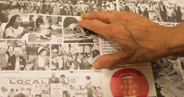 The hand of Mei Yin Tsang points to a grid of black-and-white images of protesters and activists. Several photos feature East Asian women. In one photo, a group of Black women hold placards.