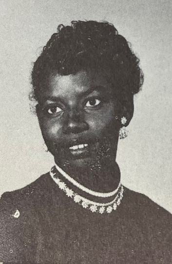 A young African American woman wearing earrings in a yearbook photograph
