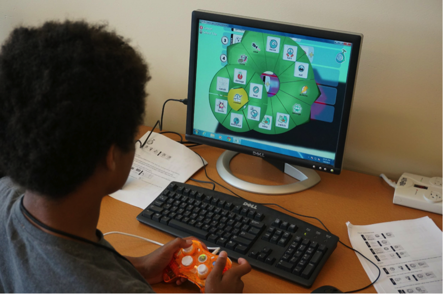 Figure 3: An image of a student sitting in front of a computer, designing a video game. 