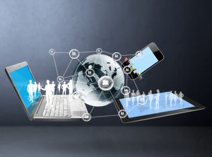 An image depicting electronic communication. It shows a laptop computer, cell phone, and electronic device with a globe in the middle.