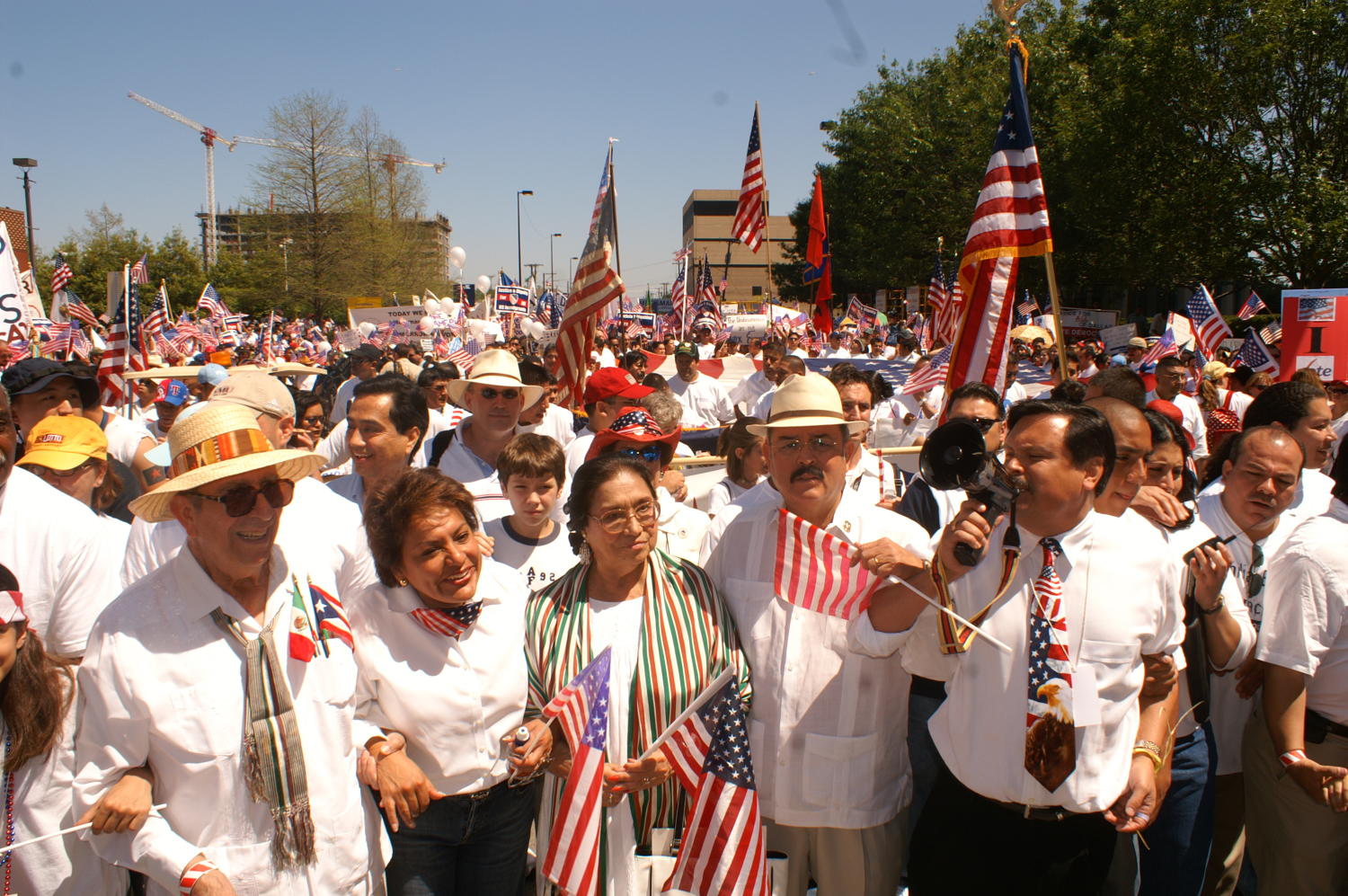Protesters march through the streets carrying signs and flags