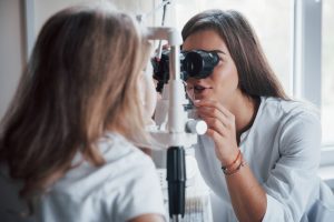 An optometrist performing an eye exam.