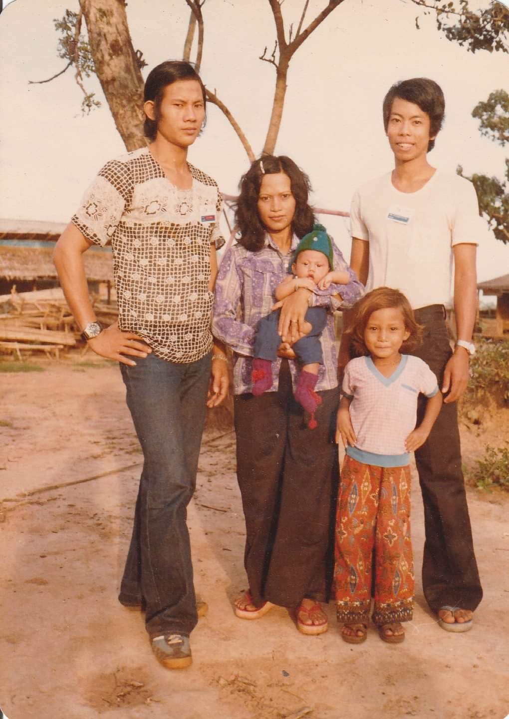 The writer, Steven Ngin, is shown as a child in a group photo with his parents, baby brother and a family friend, in the late 1970s. The photo was taken at a regugee camp in Thailand.