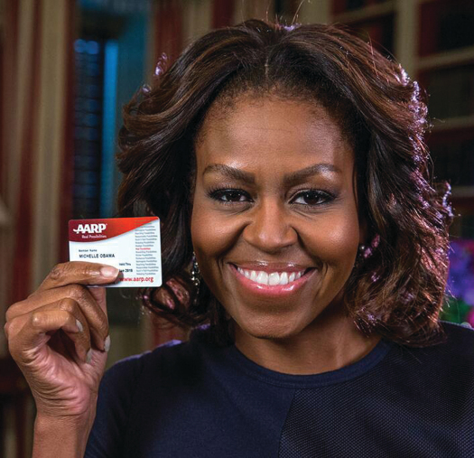 An image of Michelle Obama holding an AARP membership card.