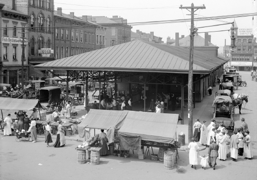 Horse and buggies line the street in this view of Findlay Market from Race Street (circa 1930).
