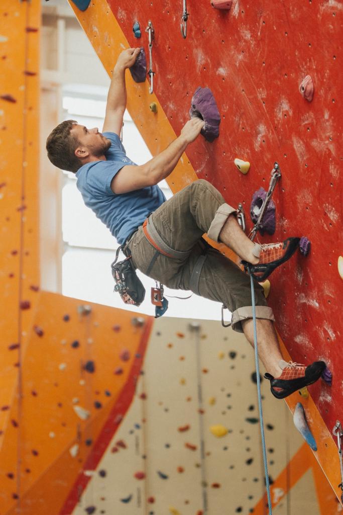 A man on an indoor rock climbing wall.