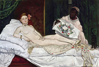 A person lying on a bed with a person holding flowers

Description automatically generated