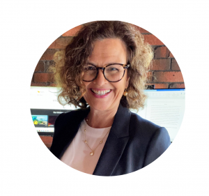 Photo of smiling curly haired woman with glasses