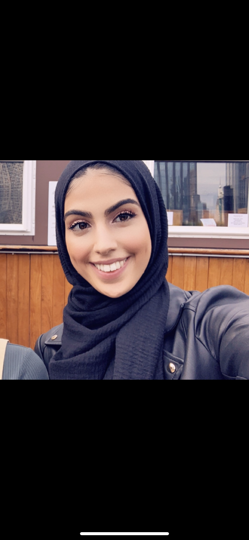 The writer, who is identifying herself as "A.K.N" is shown smiling, wearing a hijab (head scarf).