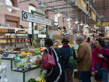 Renowned Calomiris stall. A handful of patrons stand in front of the stall.