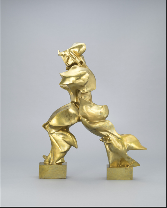 A gold statue of a person

Description automatically generated