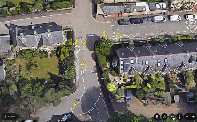 A aerial view of a street with houses and trees

Description automatically generated