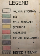 A map from 1938 of Brooklyn, NY appears alongside a legend that designates various colors as indicative of types of neighborhoods. The main colors on the map are blue (which indicates a neighborhood that is “still desirable”; yellow (“declining”); and pink (“hazardous”).