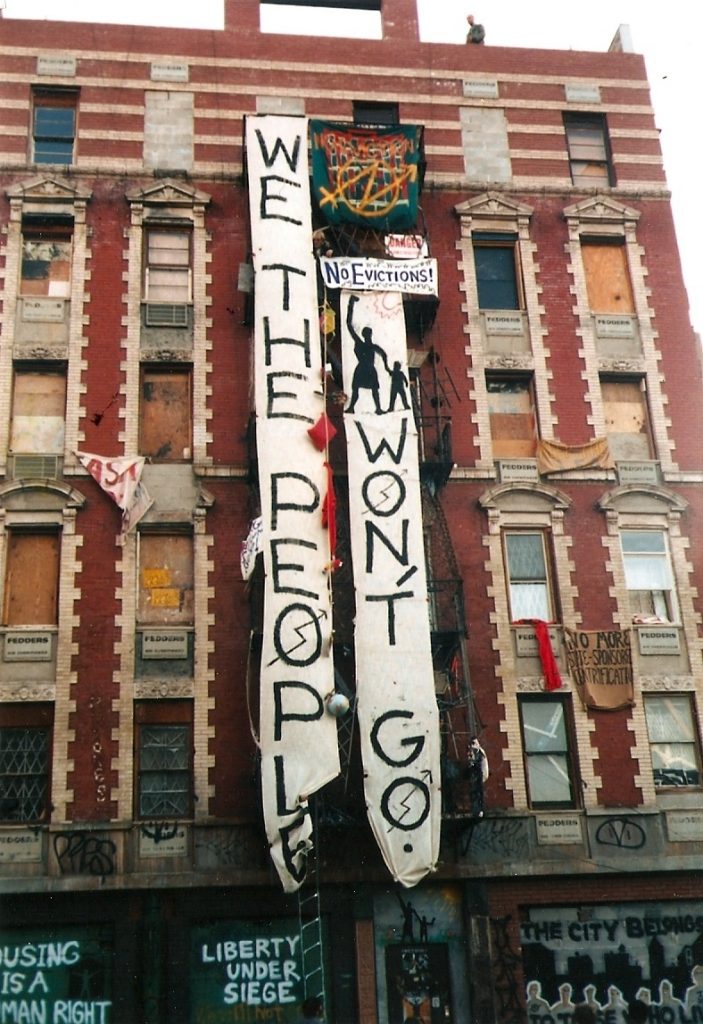 Building with vertical signs that read "We the people" and "Won't go"