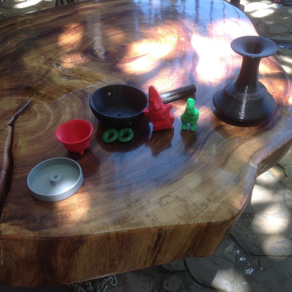Figure 12 - Closer view of the table in figure 11, showing different 3D printed objects, including vessels and small figurines.