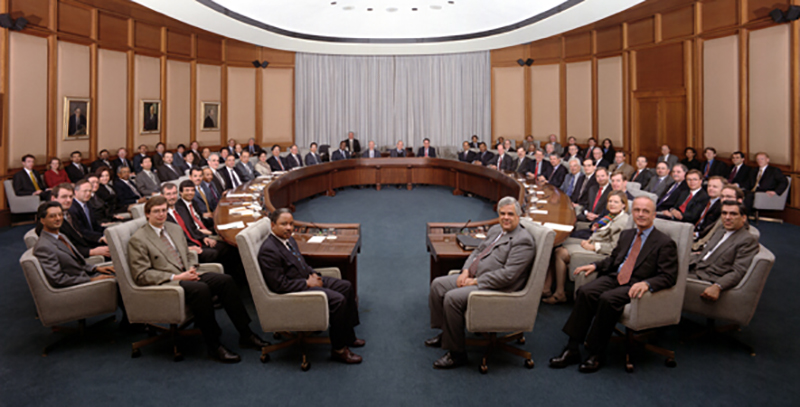 Color photo of a group of people sitting in chairs.  It is a meeting of the Board of Governors of the International Monetary Fund 

