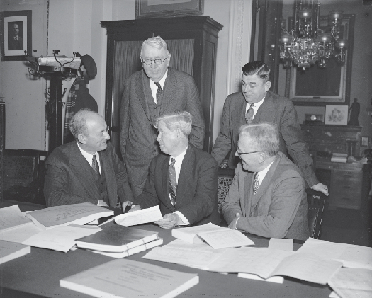 A photo of Henry Morgenthau, Jr., Daniel Bell, and three members of the House Appropriations Committee.
