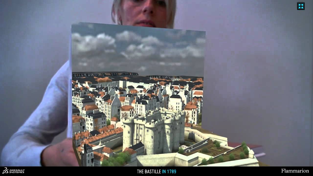 AR-enhanced book opened to show the 3D model of Paris emerging from the printed page