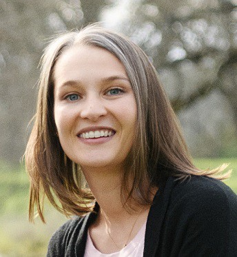 A person smiling for the camera  Description automatically generated