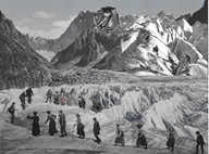 Hikers cross a sea of ice as they ascend high mountains. At the pinnacle is an ancient Greek coin with the image of an owl.