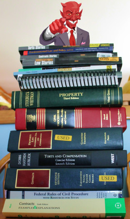 A stack of legal textbooks with a caricature of the devil on top pointing at the reader
