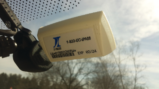 A photo of an E-Z Pass attached to the inside of a car windshield.