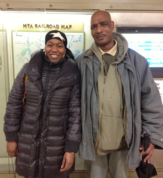 Robyn and her father are smiling, standing on a NYC subway car.