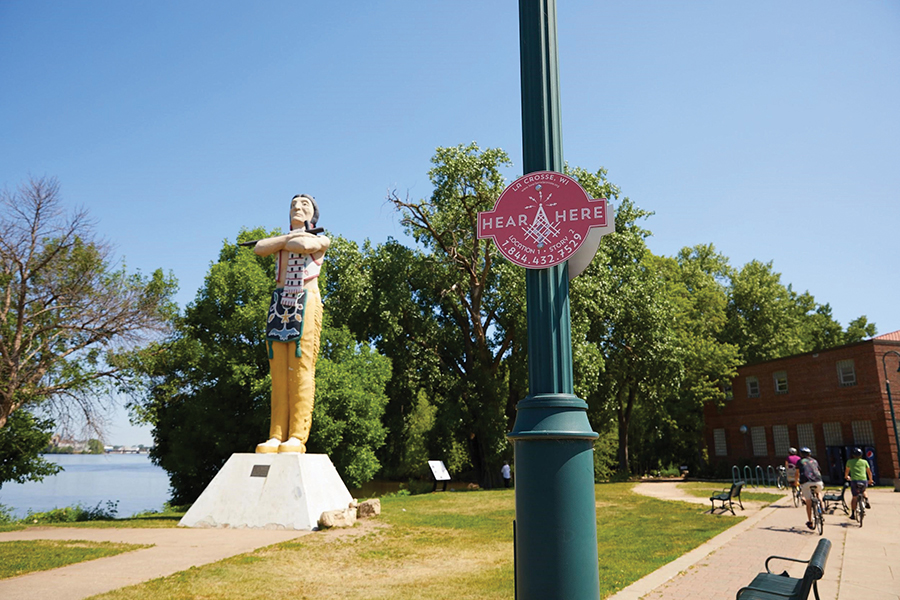 Photograph of the Hear, Here sign beside the “Hiawatha” statue in Riverside Park.
