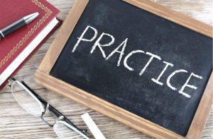 board with the word practice written in chalk
