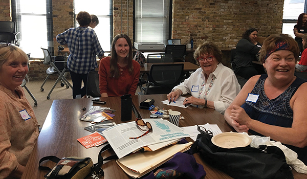 Sara Ludewig, center, conducting a group interview and looking at artifacts they brought to the Harm Reduction History Harvest in Minneapolis, May 2017. Left to right: Deb Holman, Sara Ludewig, Mary Morris, and Gayle Thomas.
