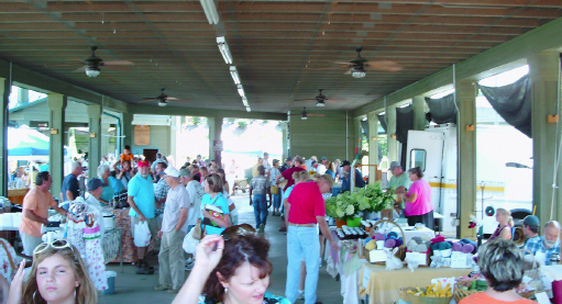 In the pavilion, with many vendors and patrons.