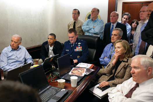 An image of Barack Obama, Joe Biden, Hillary Clinton, Robert Gates, and other national security advisors in the White House Situation Room.