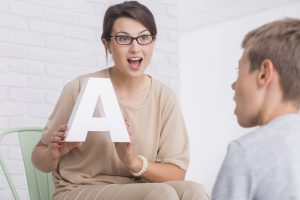 A speech-language pathologist with a patient.