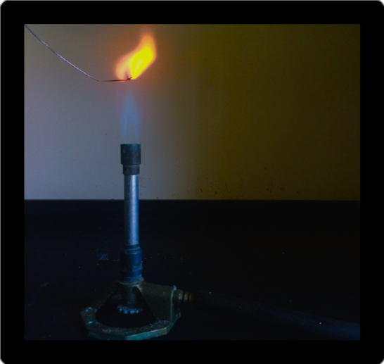 Fame test for sodium showing bright orange flame.
