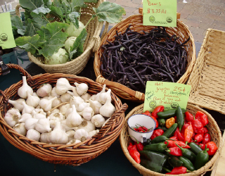 Baskets full of produce (i.e: Garlic, string beans, peppers).