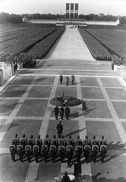 A group of soldiers marching on a race track

Description automatically generated with low confidence