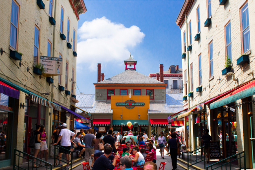 Market Center busy in mid-afternoon, with market goes enjoying lunch on outdoor benches.
