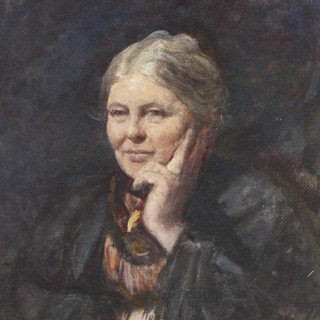 A painted color portrait of Charlotte Mason. She is wearing a large cloak and a high-neck top/dress. She is resting her cheek against her hand and she is smiling in a thoughtful, yet whimsical way. Her hair is gray-colored and she tied back into a loose bun. Photo Credit: Frederic Yates (1902) via Wikimedia Commons.