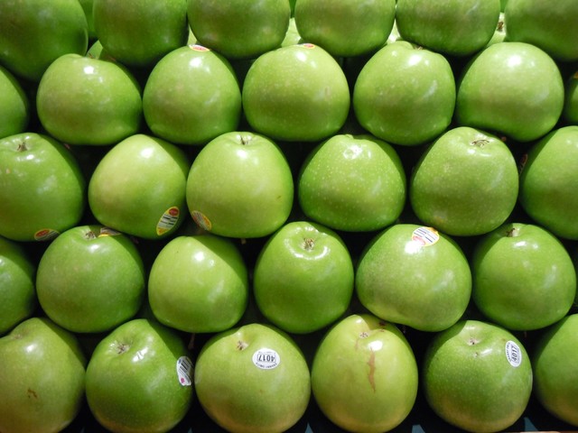 A group of green apples in repitition rows