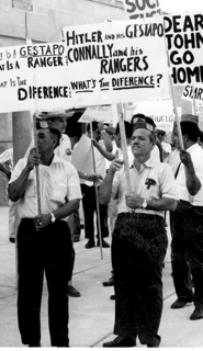 Members of the American GI Forum picketing while carrying signs